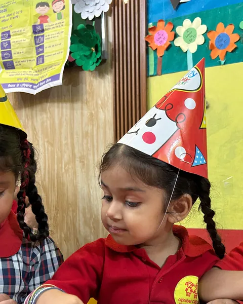Children in party hats at the red table
