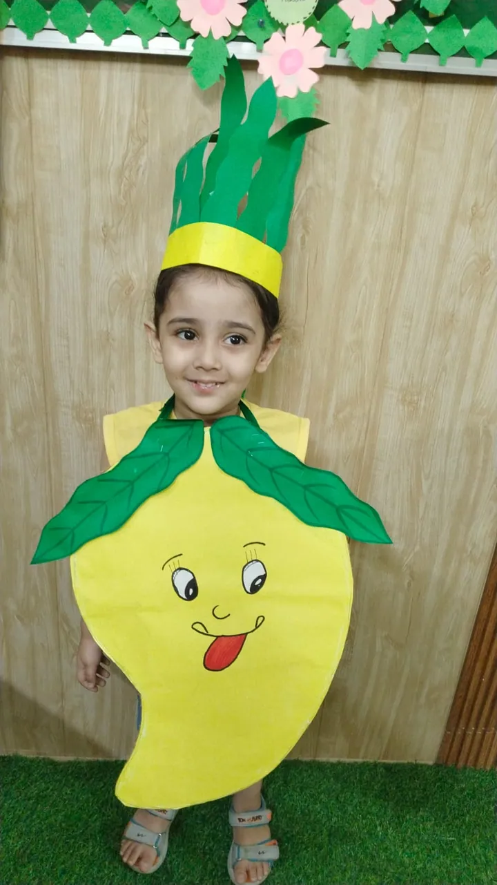 A little girl dressed as a mango